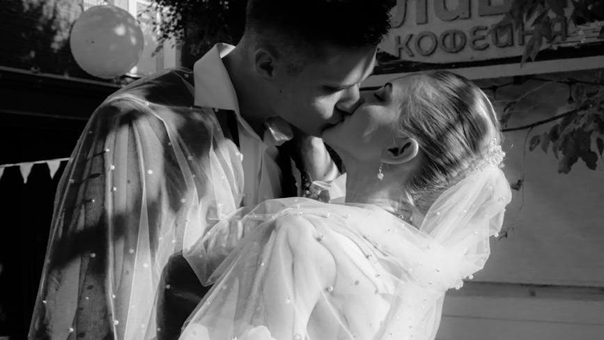 romantic newlywed kiss captured outdoors